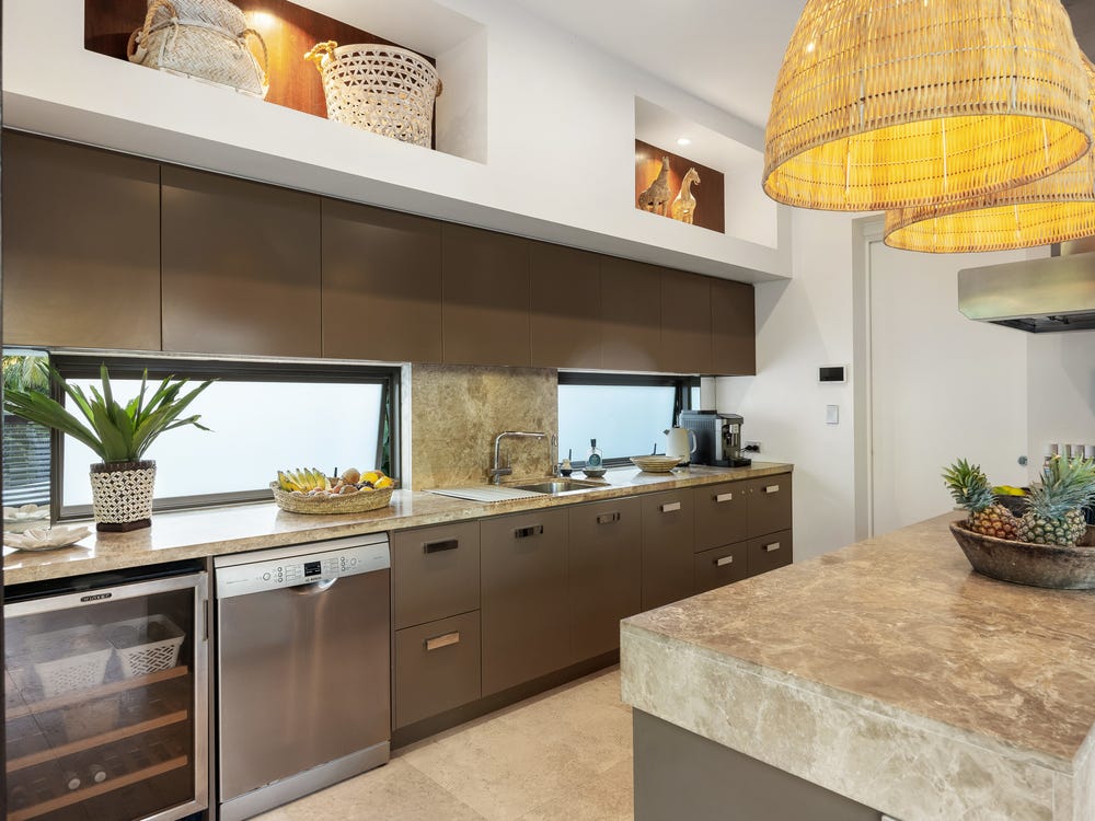 Angkasa kitchen with stone island and woven pendant light